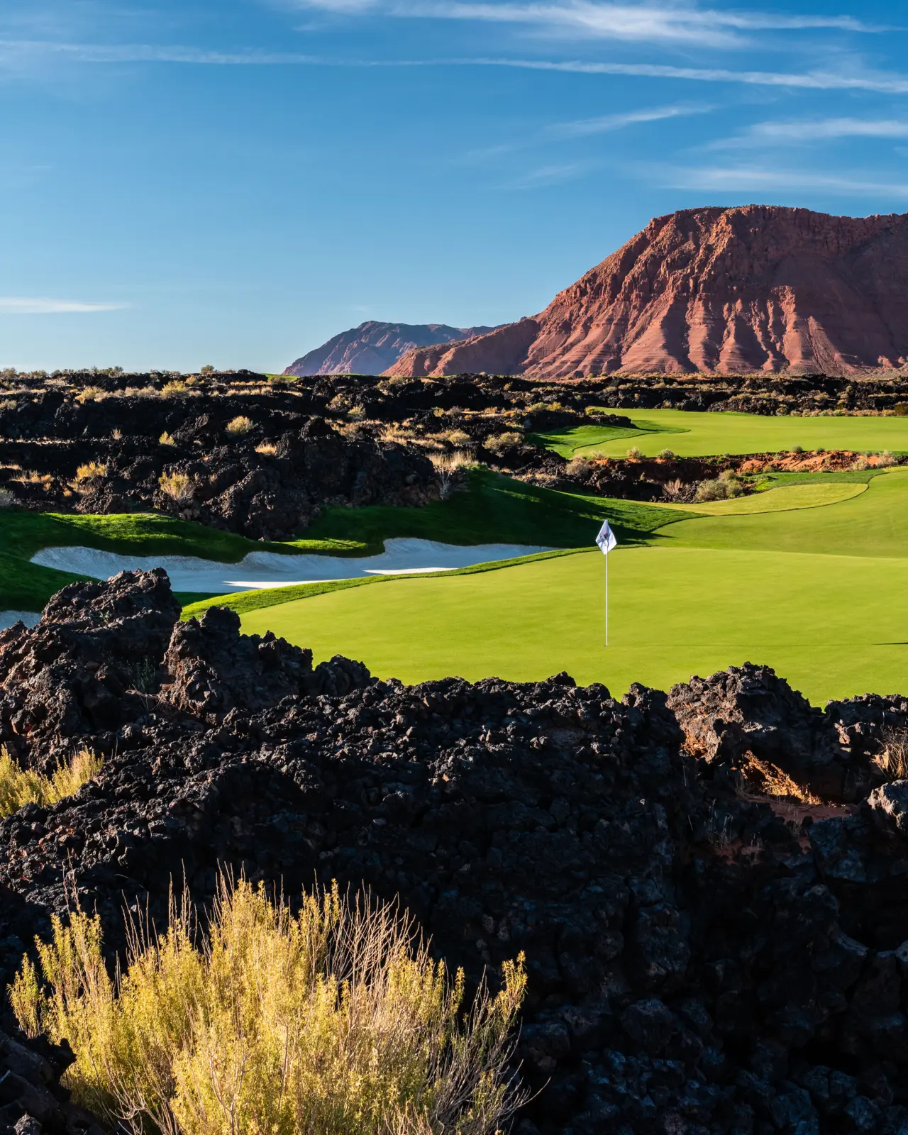 A view of hole one at Black Desert golf course with a view of the mountains surrounding the course
