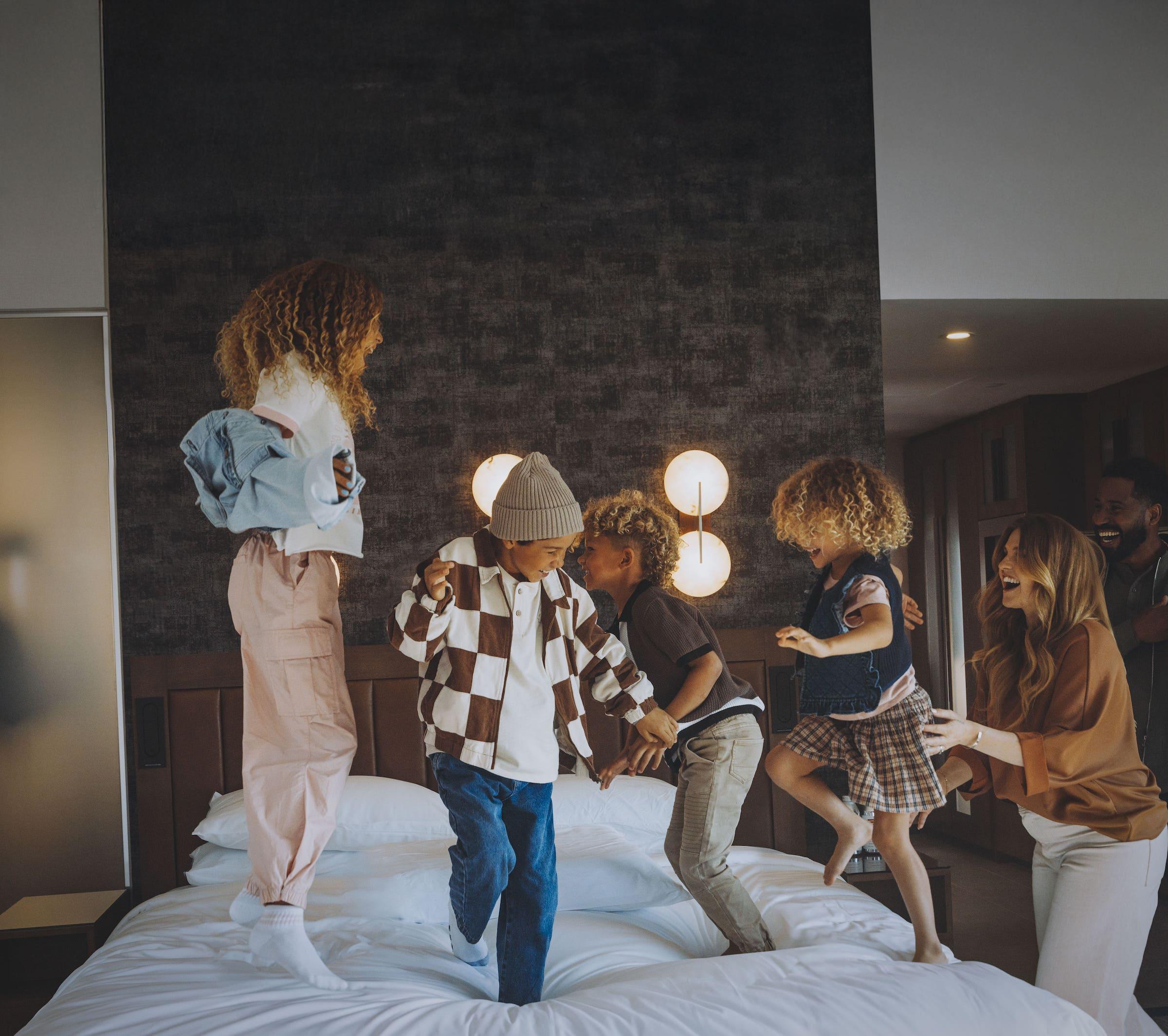 Kids jumping on a bed
