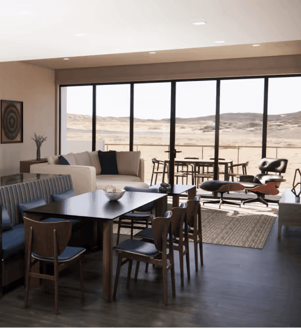A modern, open-concept living and dining room with floor-to-ceiling windows that provide a panoramic view of a desert landscape.