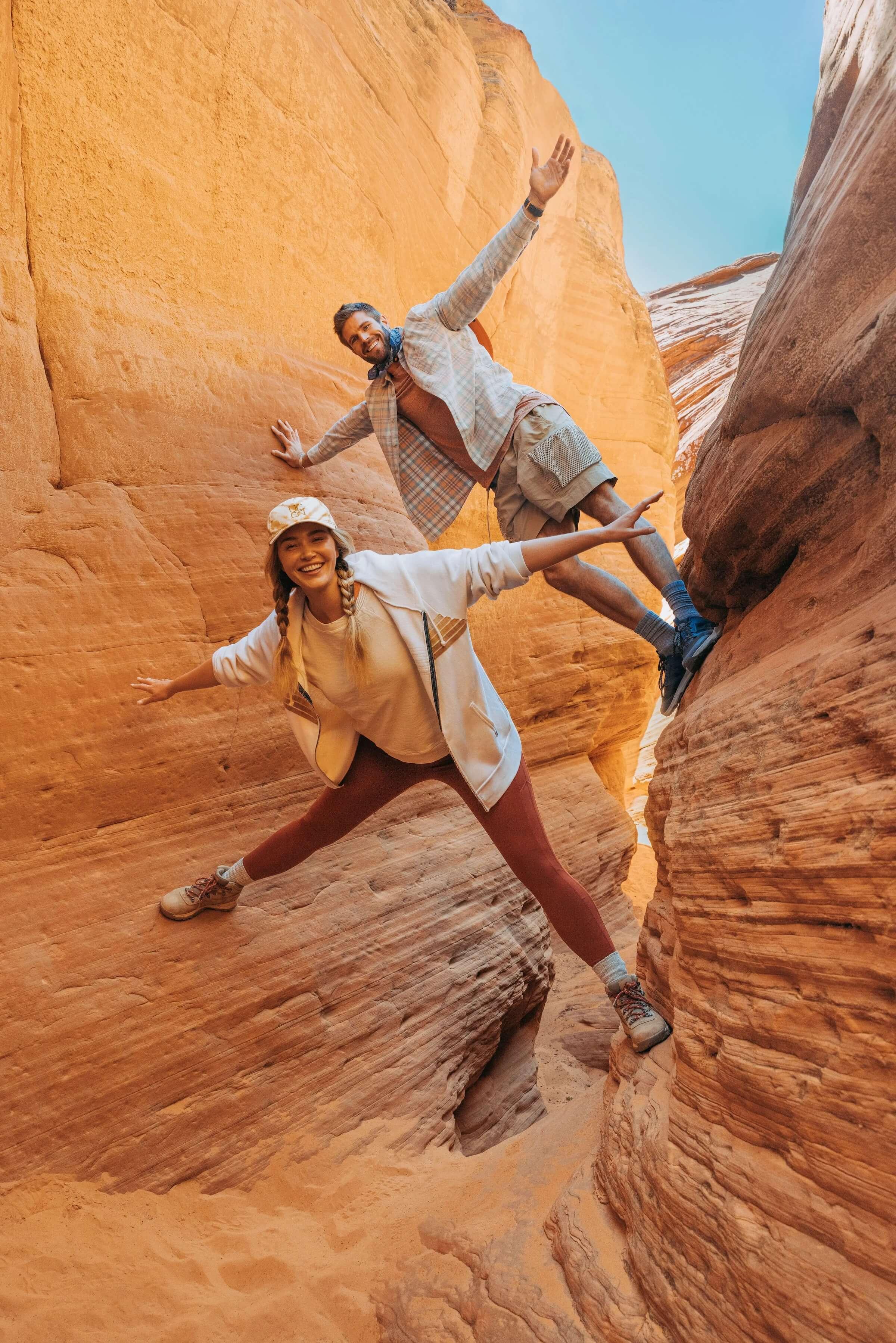 Two people climbing a rock in the desert having fun near BlackDesert Resort