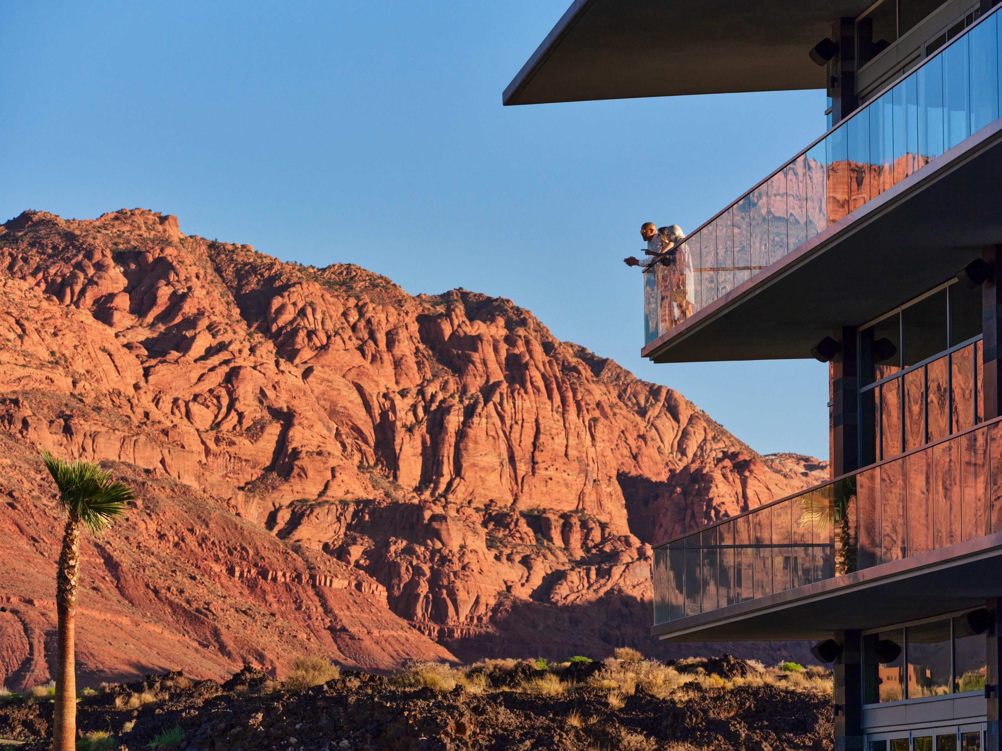 People standing on balcony overlooking desert
